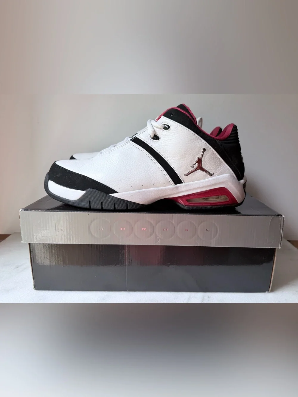 Nike Jordan Team Reign Low sneakers in a white, black, and red colorway,